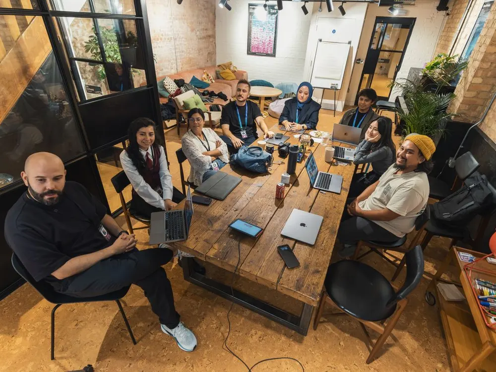 The team gathered around a table collaborating