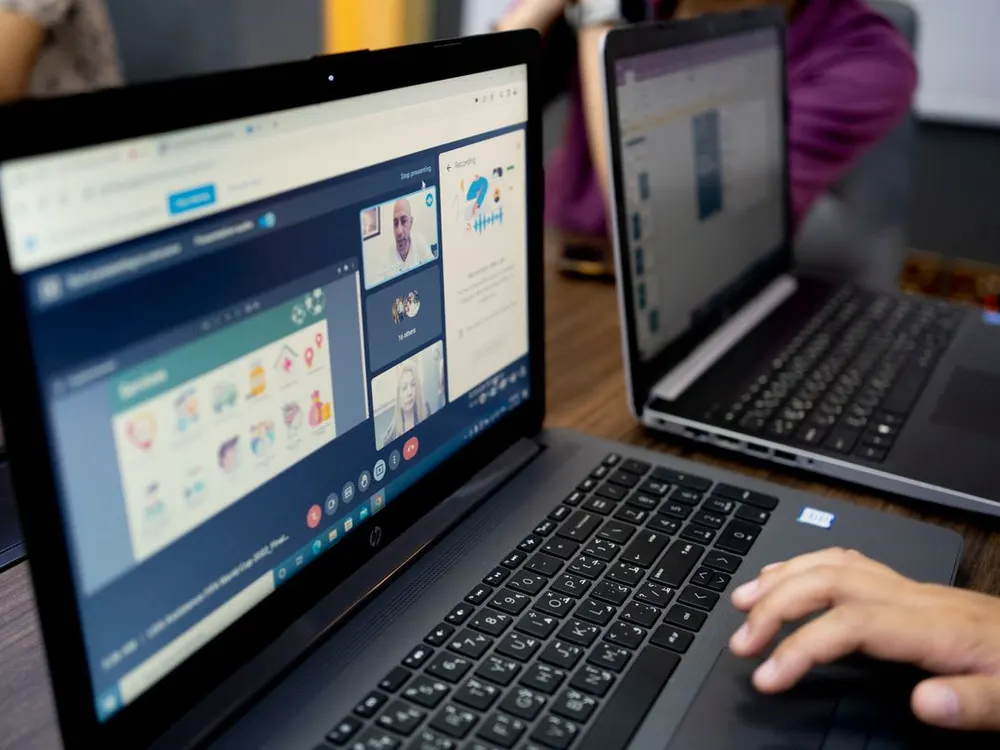 Laptop screen showing a remote team video call